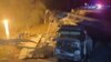 This handout photograph taken and released by the Moscow Interregional Transport Prosecutor's Office early on June 1, 2025 shows Russian law enforcement officers working at the site of a bridge collapse in the Vygonichi district of the Bryansk region.